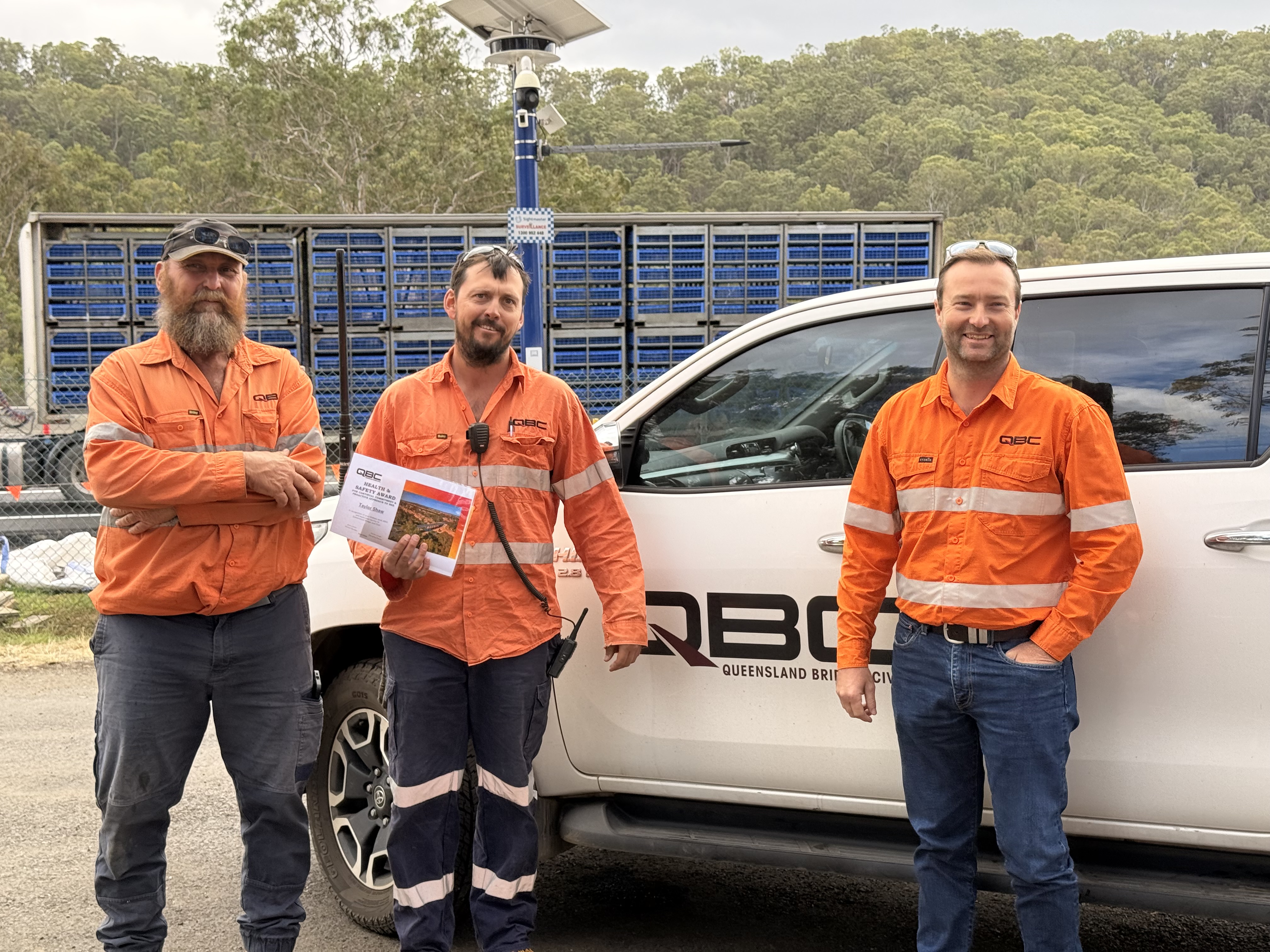 QBC team members alongside the company ute, recognised with a Health & Safety Award - loyalty and recognition that goes both ways